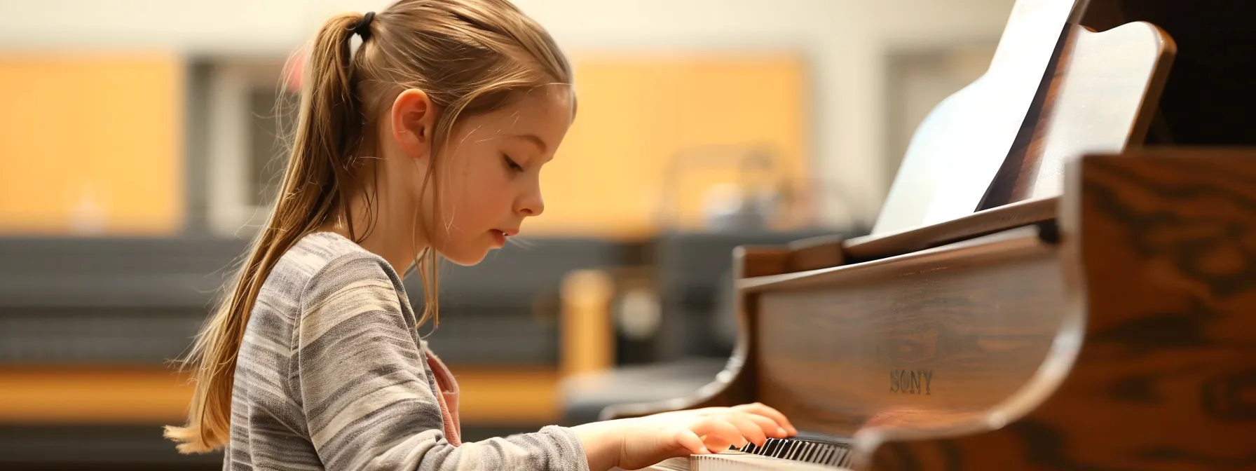a student learning proper piano posture during their first lesson at wkmt.