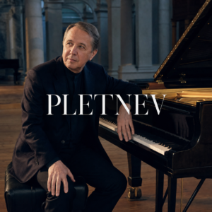 Mikhail Pletnev beside a concert grand piano in London