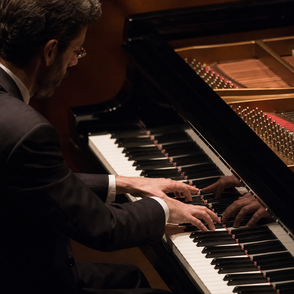 Pianist hands shaping Beethoven at a grand piano